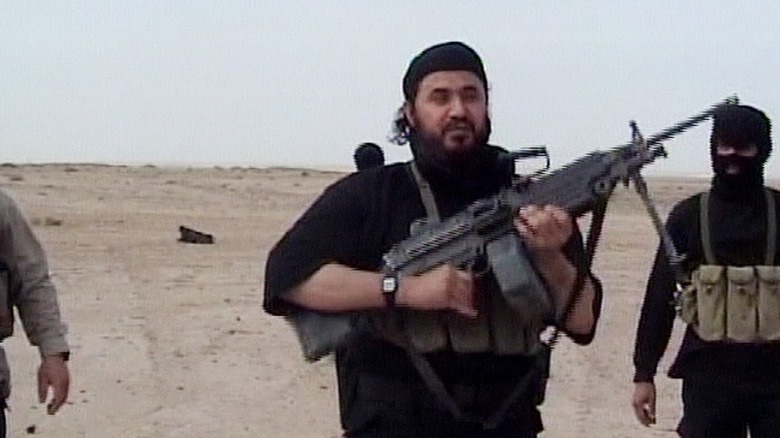 Abu Musab al-Zarqawi holding rifle