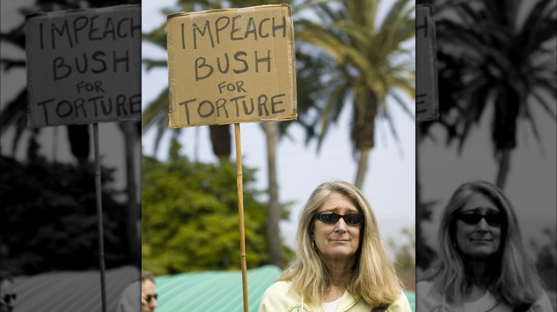 Woman holding anti-torture sign