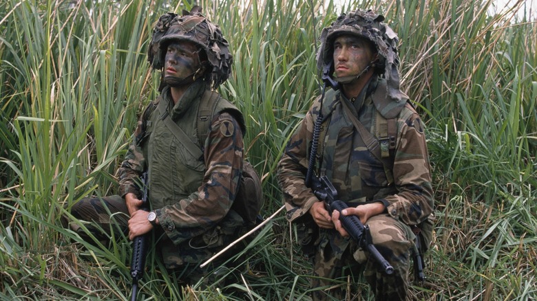 Two U.S. soldiers kneeling in grass