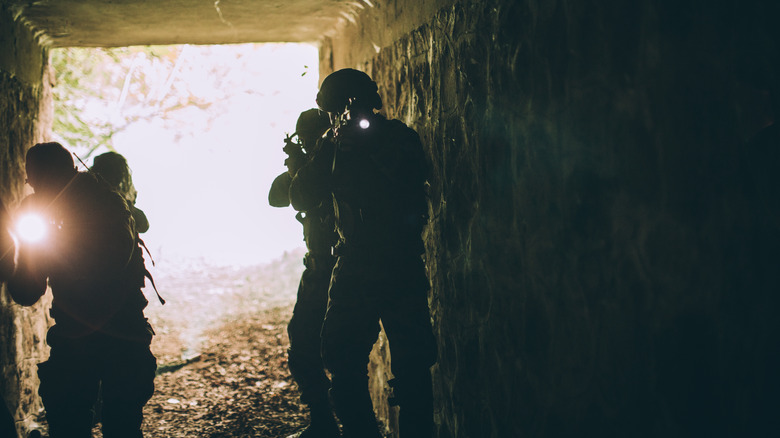 soldiers in dark tunnel