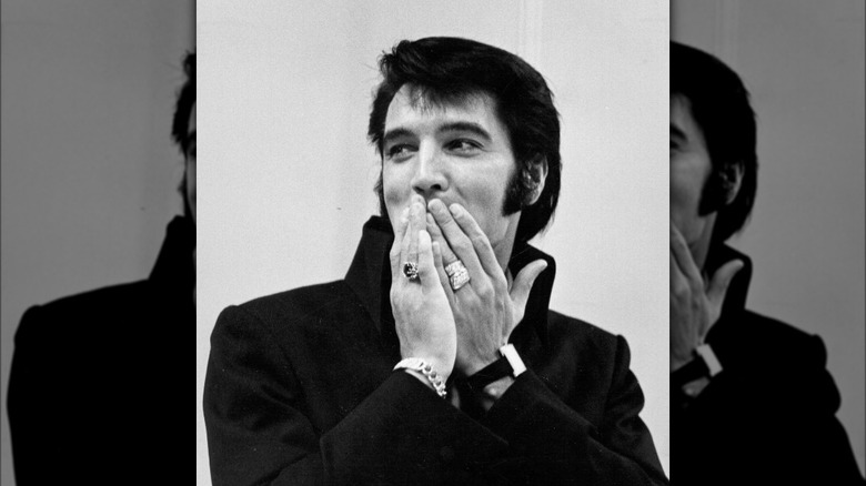 Elvis Presley hands over mouth