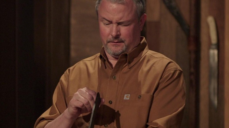 j neilson examining a blade on forged in fire