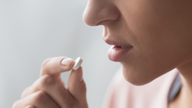 Woman taking pill