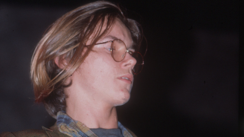 River Phoenix wearing glasses