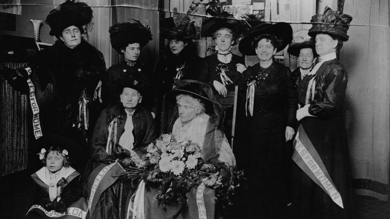 Woodhull sits among suffragists