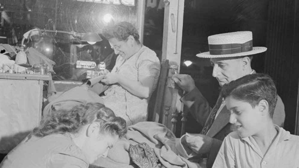 Jewish weaving shop with workers sewing