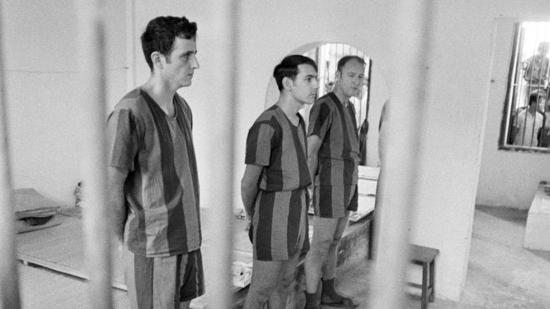 US POWs standing in Vietnam prison