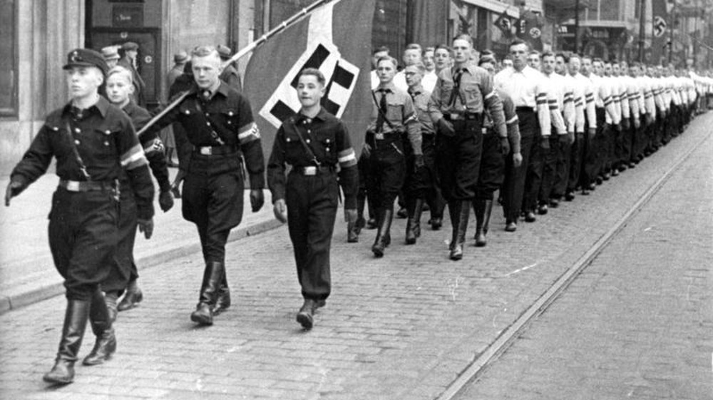 Hitler Youth marching in street