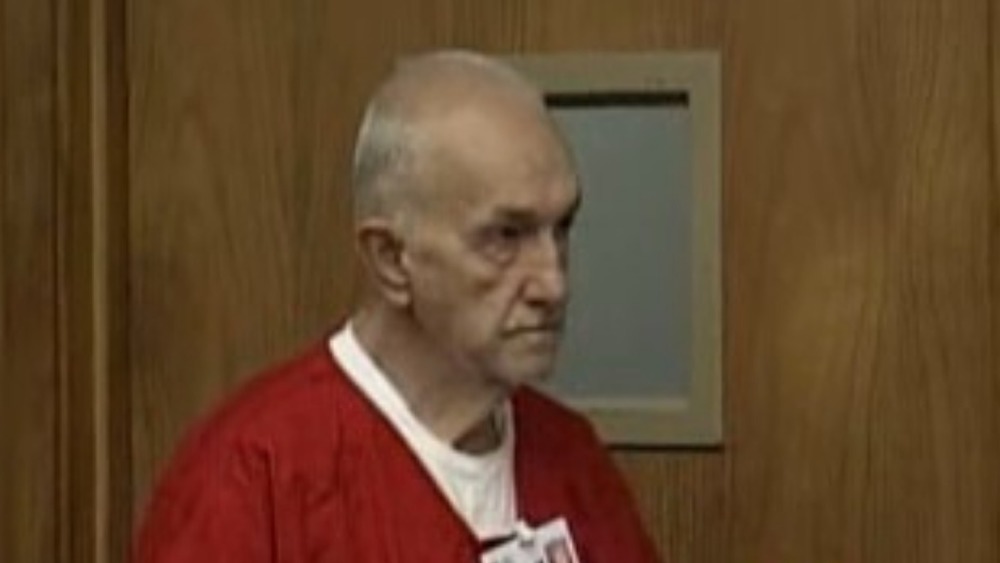 Roger Reece Kibbe, in courtroom in prison jumpsuit