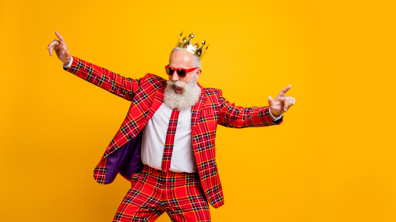 king dancing in plaid suit