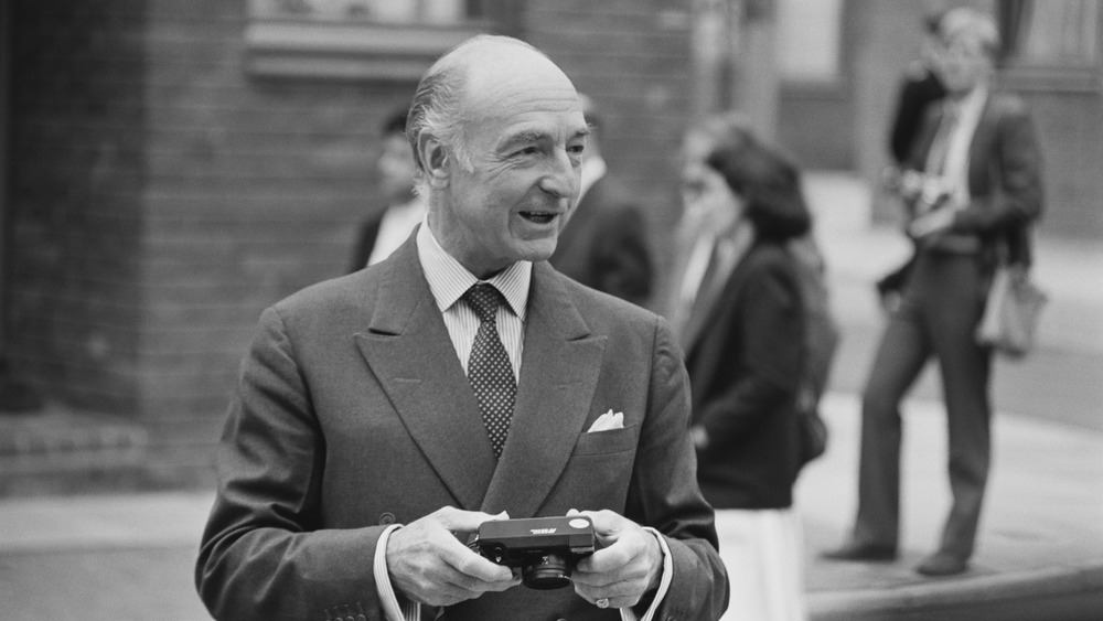 John Profumo holds a camera