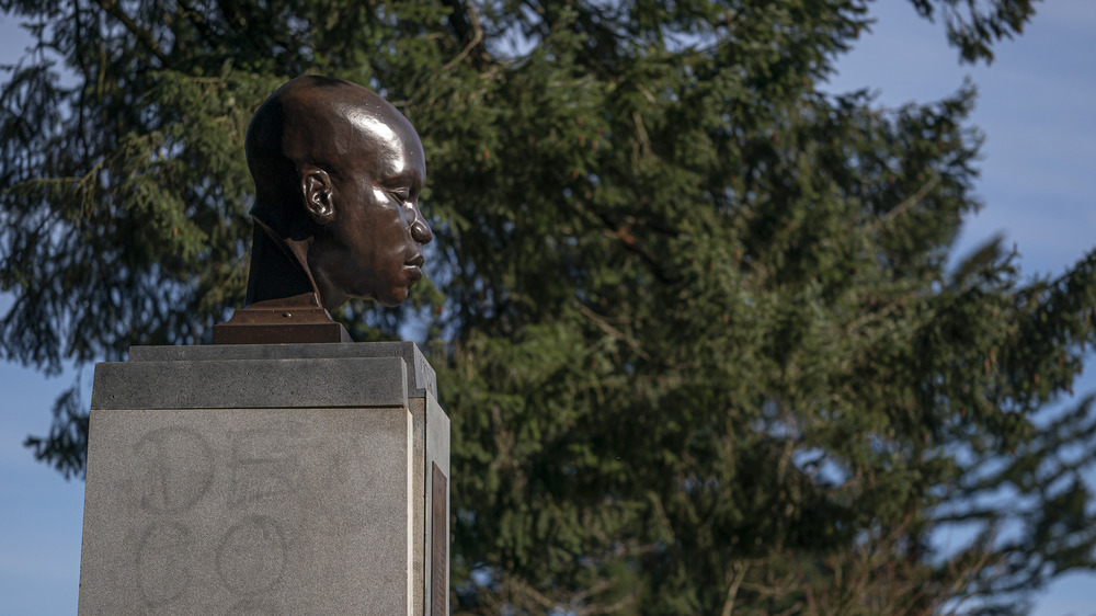 A visitor examines a statue of York, the only Black member of the Lewis and Clark Corps of Discovery, which was mysteriously erected last week in Mt. Tabor Park on March 1, 2021 in Portland, Oregon