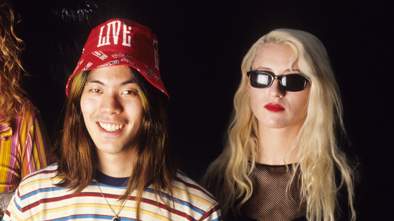 Smiling James Iha stoic D'arcy Wretzky