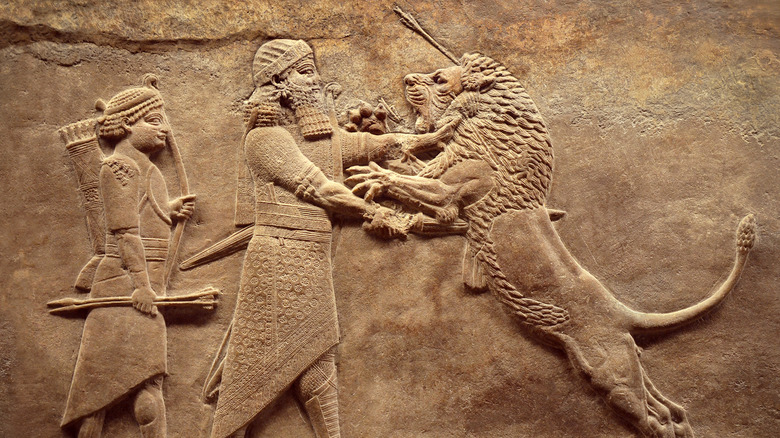 Mesopotamian carving king battling lion