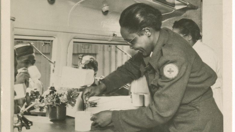 A volunteer serving coffee