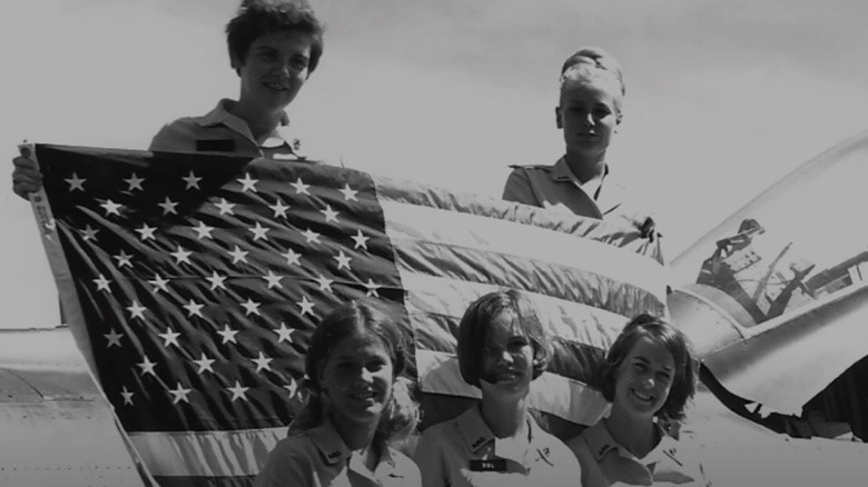 Donut Dollies holding the American flag