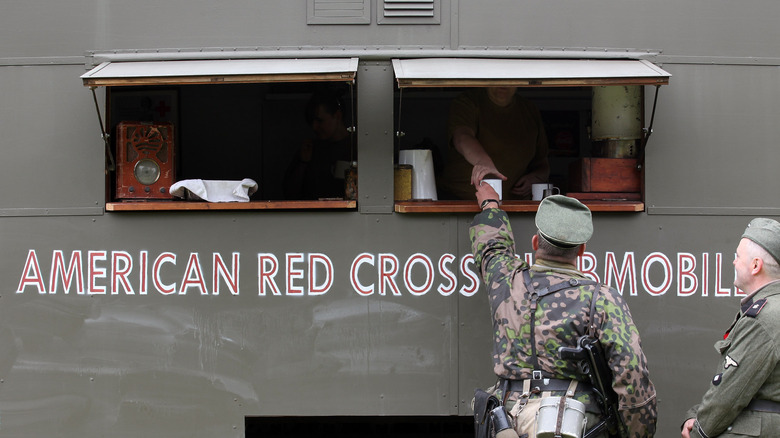 A man reaches for a cup of coffee