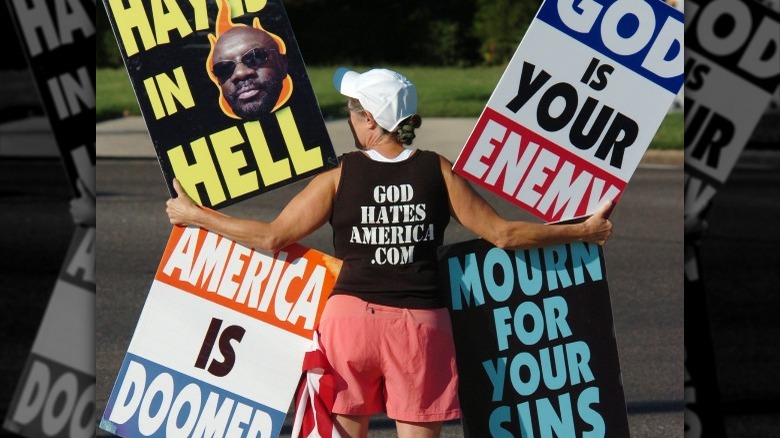 Church member holding protest signs