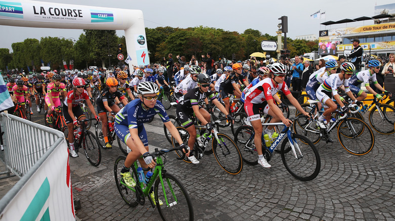 female cyclists passing starting line