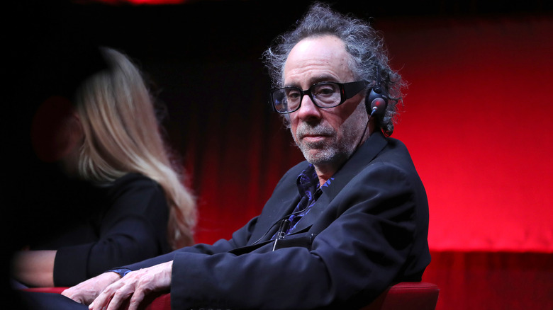 Tim Burton on stage red curtain