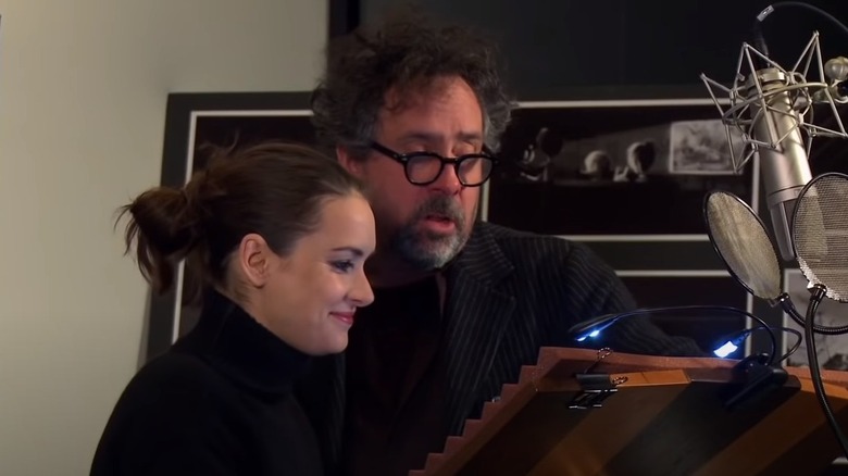 Tim Burton and Winona Ryder looking at script