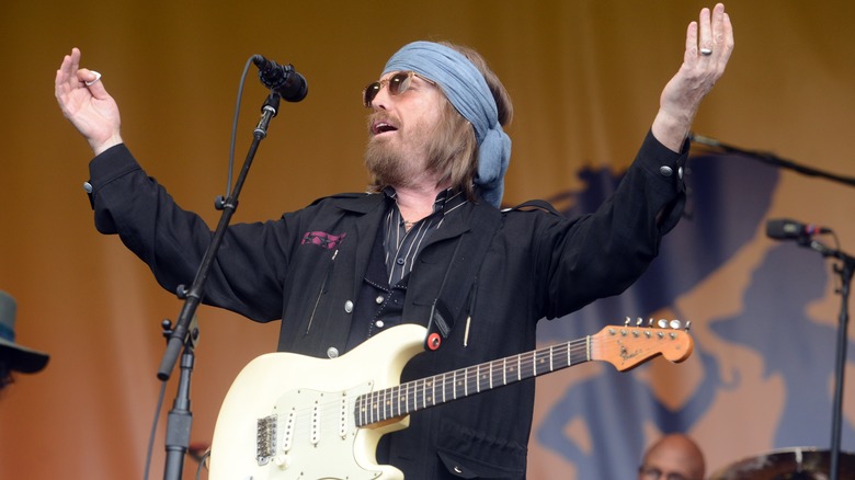 Tom Petty hands raised performing