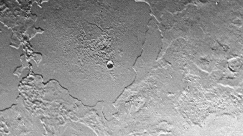 An isolated crater on Triton's surface.