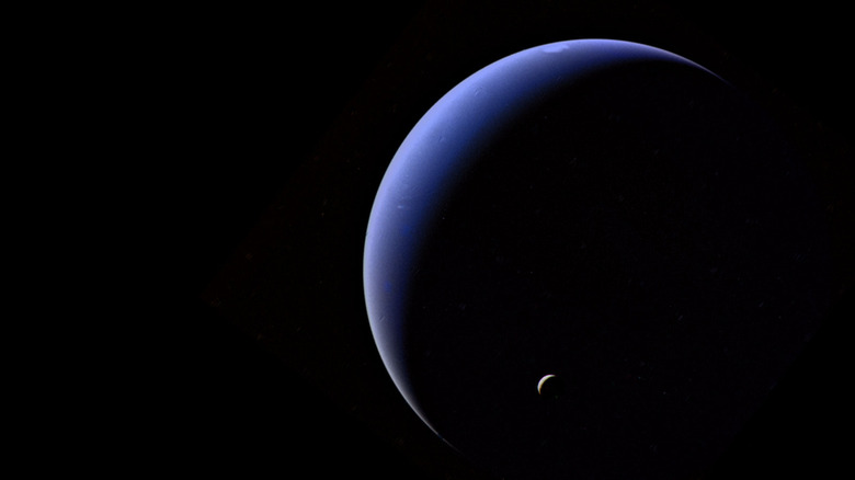 Triton, dwarfed by Neptune.