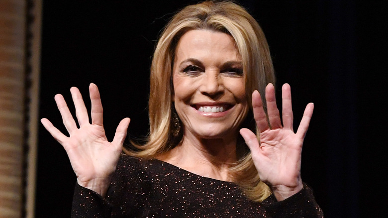 Vanna White holding up her hands