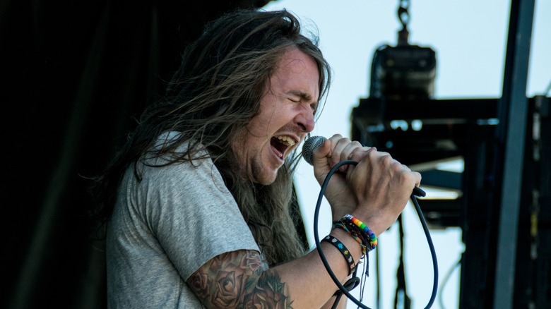 Derek Sanders on stage long hair singing