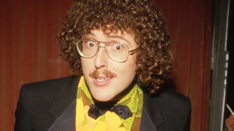 Weird Al Yankovic leans forward and stares into the camera in 1985.