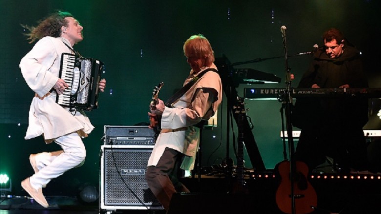 Weird Al Yankovic performs on stage with his band.