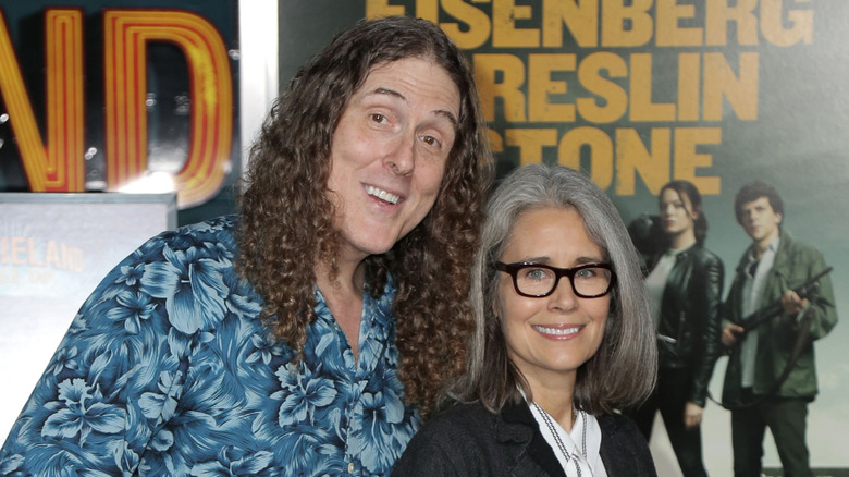 Weird Al Yankovic and his wife, Suzanne, smile at the Zombieland 2 premiere.