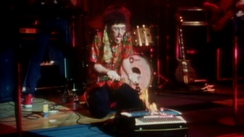 This still image is from The Compleat Al (1985) with Yankovic kneeling on stage.