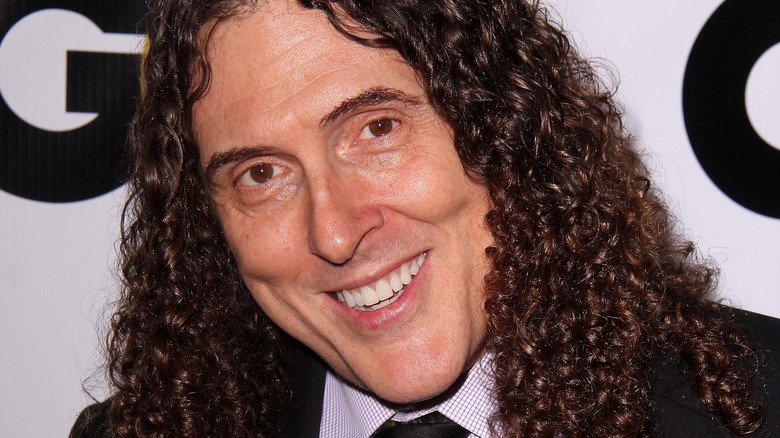 "Weird Al" Yankovic is smiling at an event.