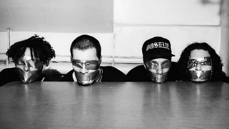 Rage Against the Machine with their eyes and mouths covered with duct tape in 1992