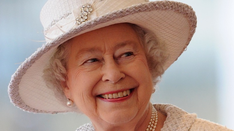 Queen Elizabeth smiling white hat