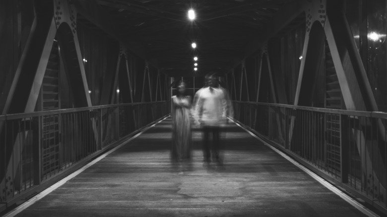 Creepy couple on a bridge