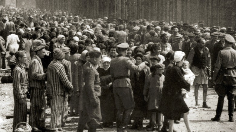 Nazis and Jews standing in Auschwitz