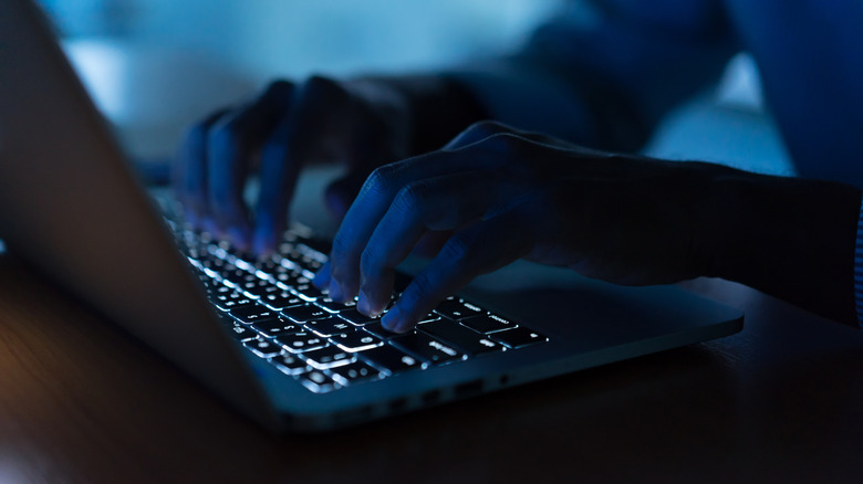 man using laptop keyboard