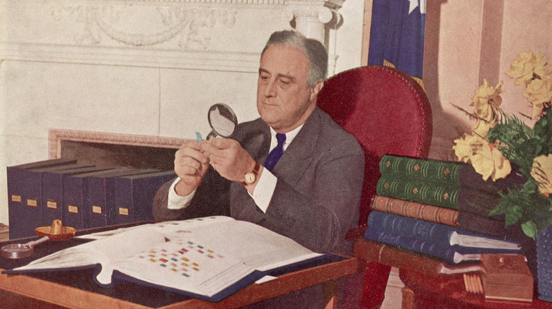 Franklin D. Roosevelt looking at stamps