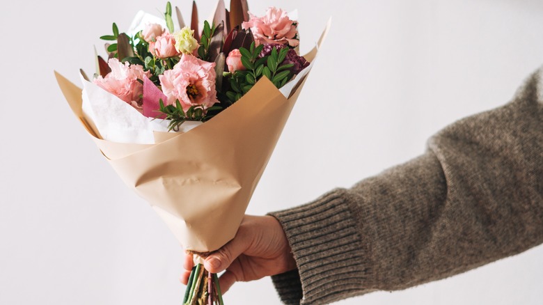 man holding flower bouquet 