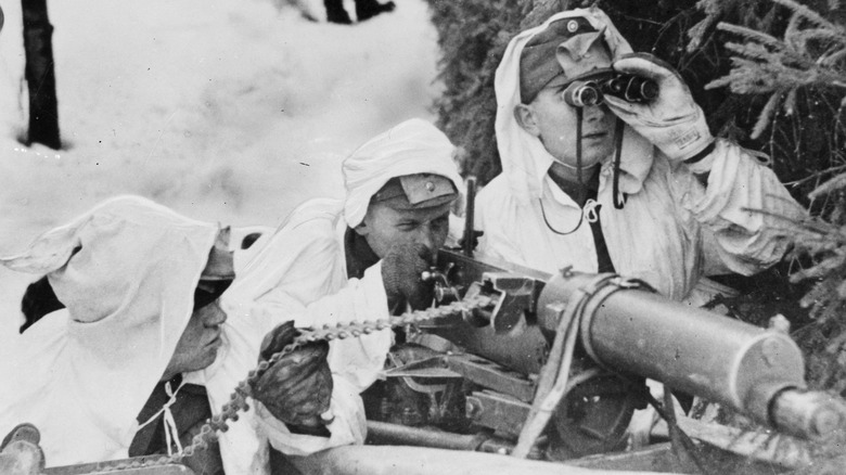 Finnish troops aiming a machine gun