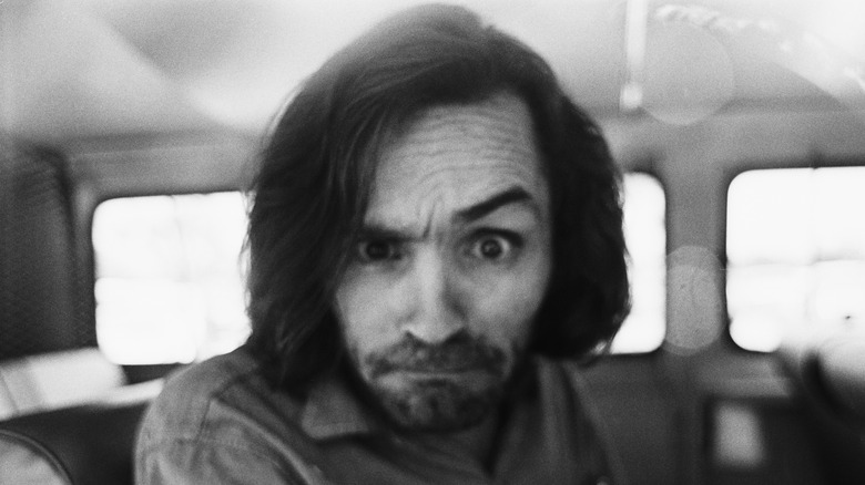 Charles Manson smirking in car