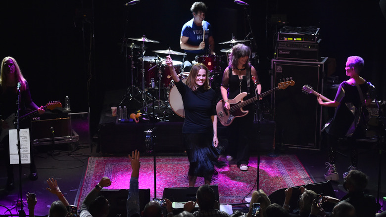 The Go-Go's performing live arm raised smiling