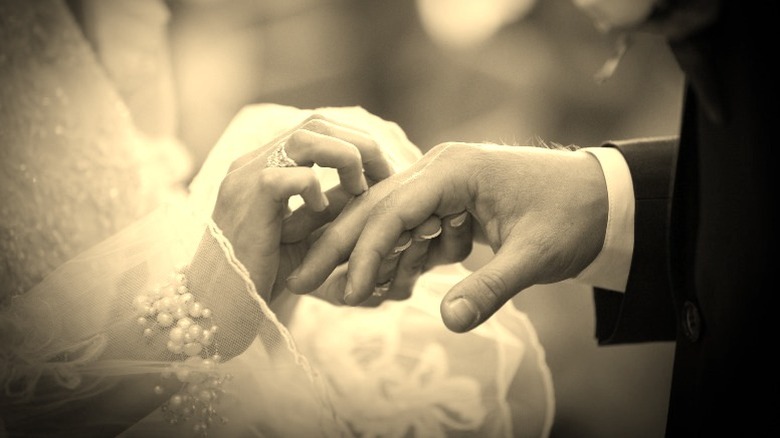 Bride and groom hands during ring exchange