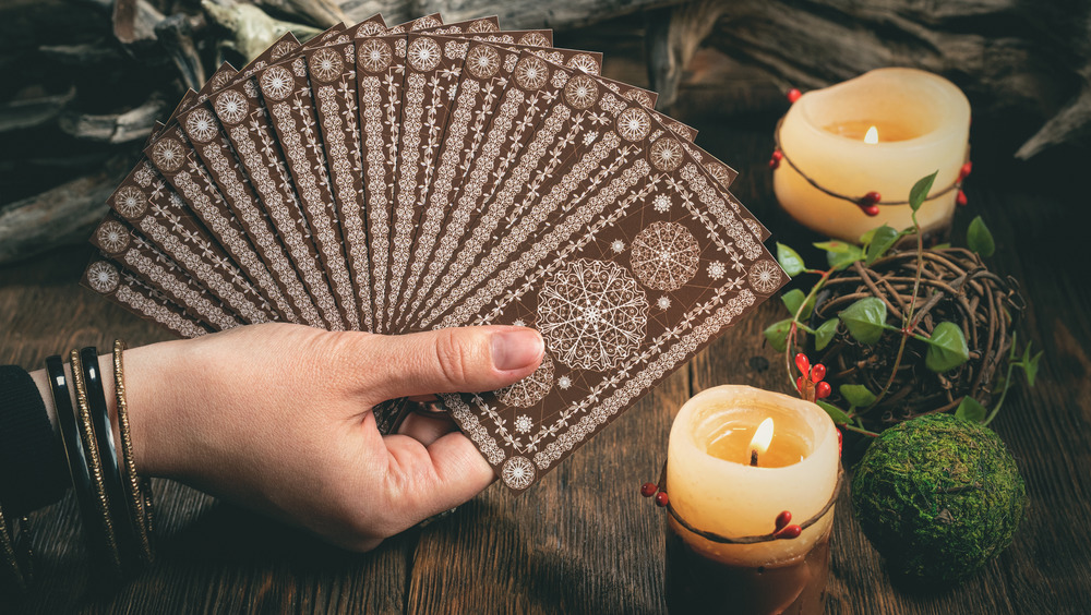 Hand holding tarot cards