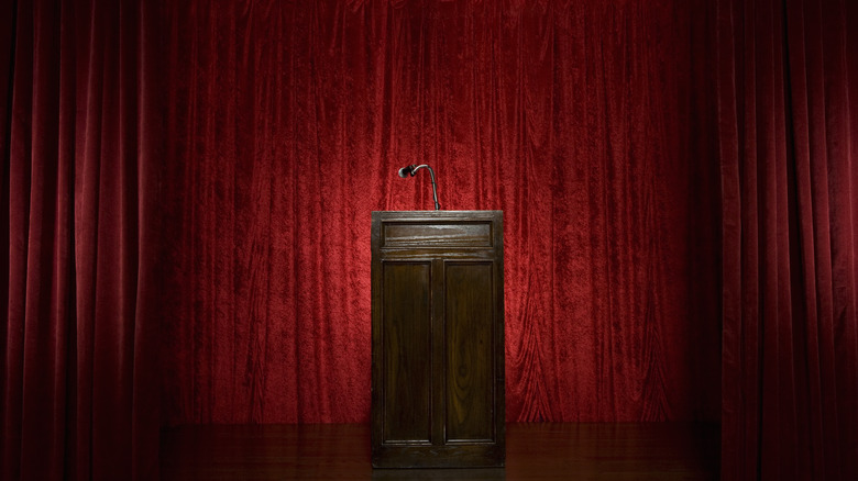 Empty podium with red curtain