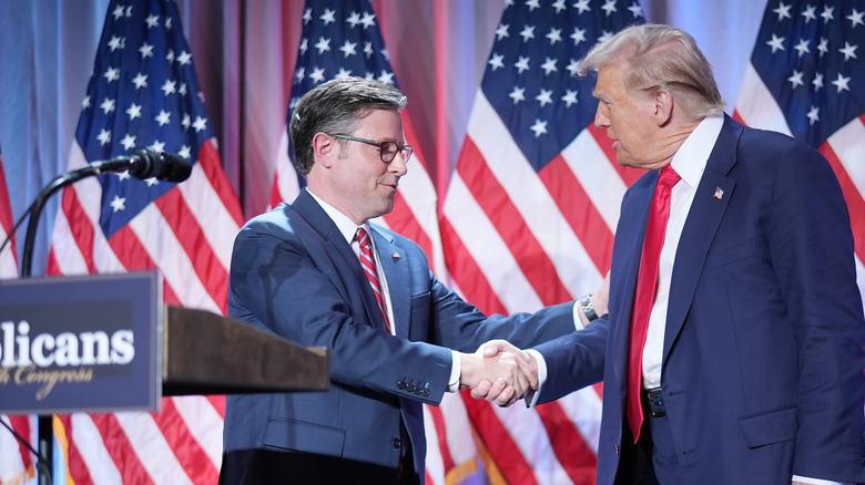 Speaker Mike Johnson shakes hands with President-elect Donald Trump