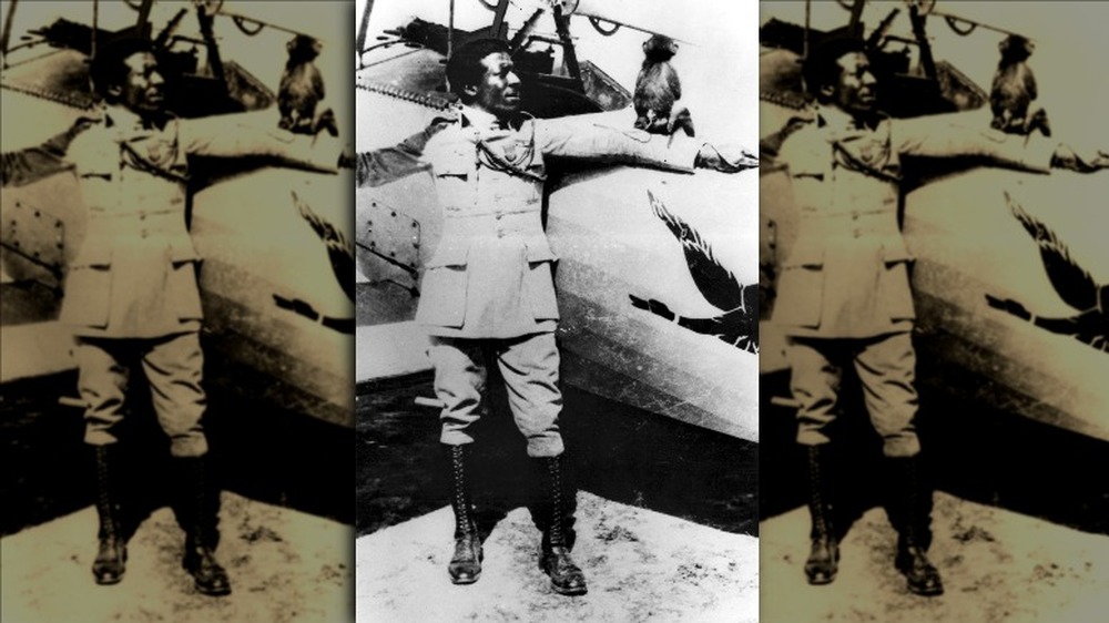 Eugene Bullard poses with his plane and his pet monkey Jimmy